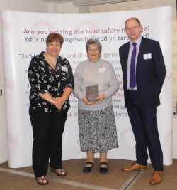 Pictured is Daisy Lambe receiving her Road Safety Wales Award from Sue Storch, Chair of Road Safety Wales, and Chris Hume from Go Safe (and Deputy Chair of Road Safety Wales).